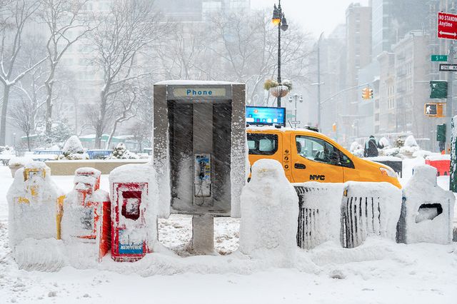 snow falls on a cab near 5th Avenue